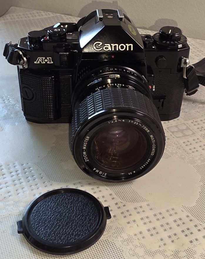 Canon A-1 35mm SLR film camera with a vintage Sigma Zoom-Master 35-70mm f/2.8-4 lens.