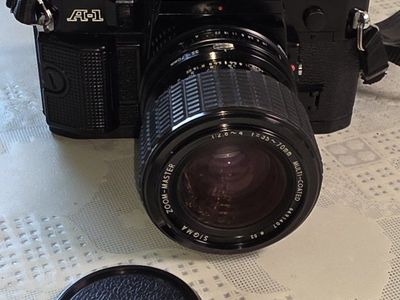 Canon A-1 35mm SLR film camera with a vintage Sigma Zoom-Master 35-70mm f/2.8-4 lens.
