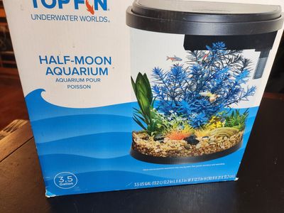 3.5 gallon half moon shaped Top-Fin tank with nice LED lights, and filter. Good small tank...needs a cleaning.