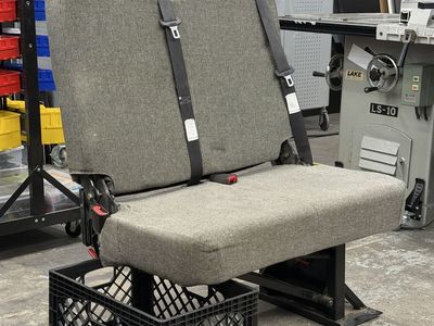 Used Gray Two-Seater Fold Down Bench Seat with Seatbelts. Perfect for a van build.