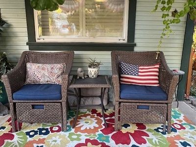 Whicker chair set with hideaway ottomans and table.