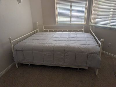 Queen size trundle day beds with full sized roll bed underneith.