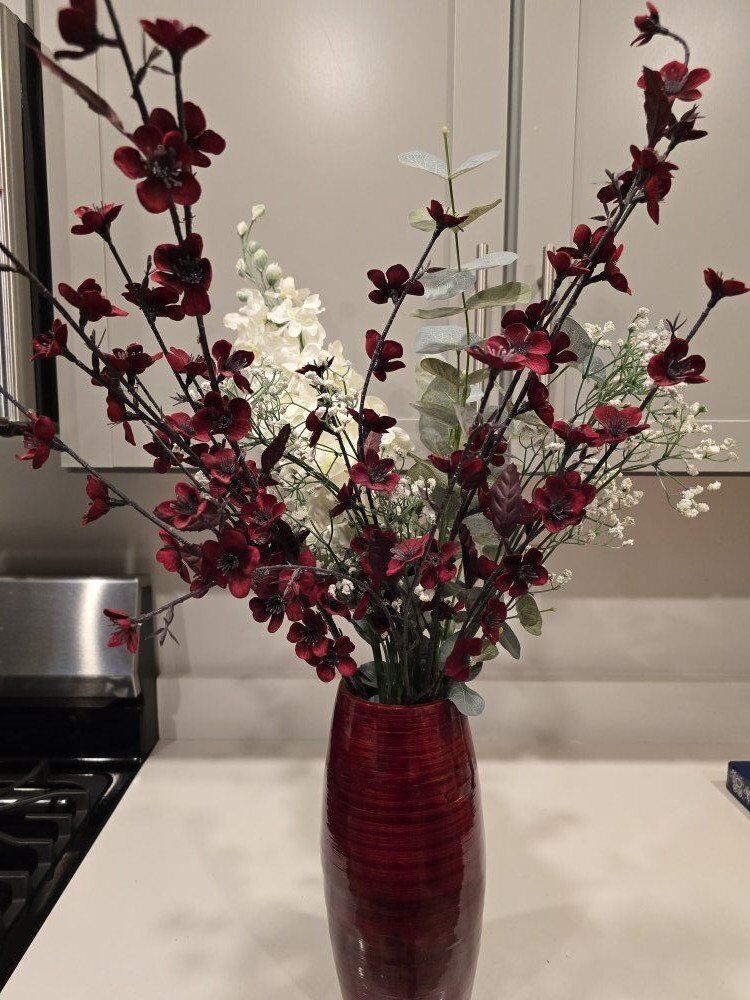 Red bamboo round vase with artificial flowers