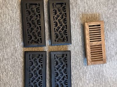 Four cast iron floor registers