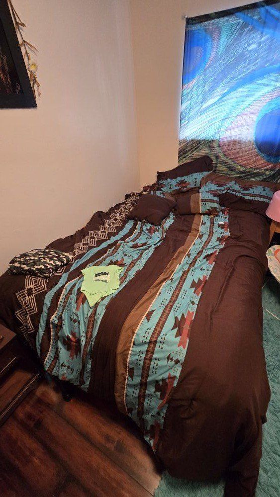 Queen sized bed with mattress, pillows and sheets