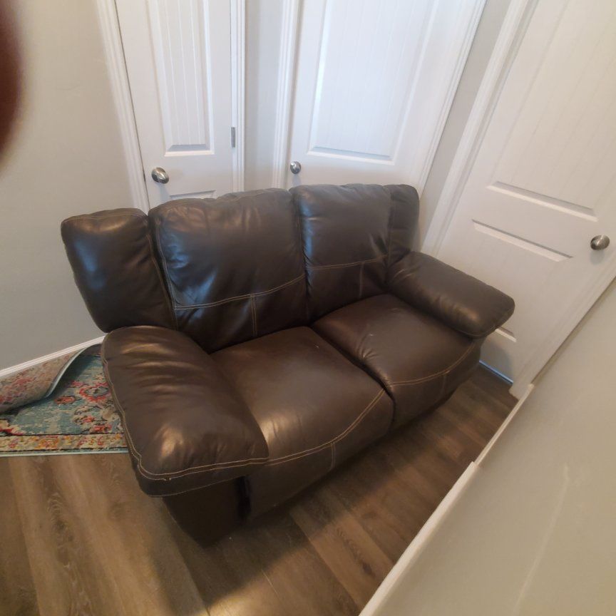 Brown leather couch and love seat