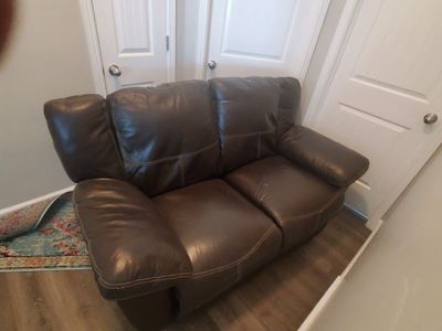 Brown leather couch and love seat