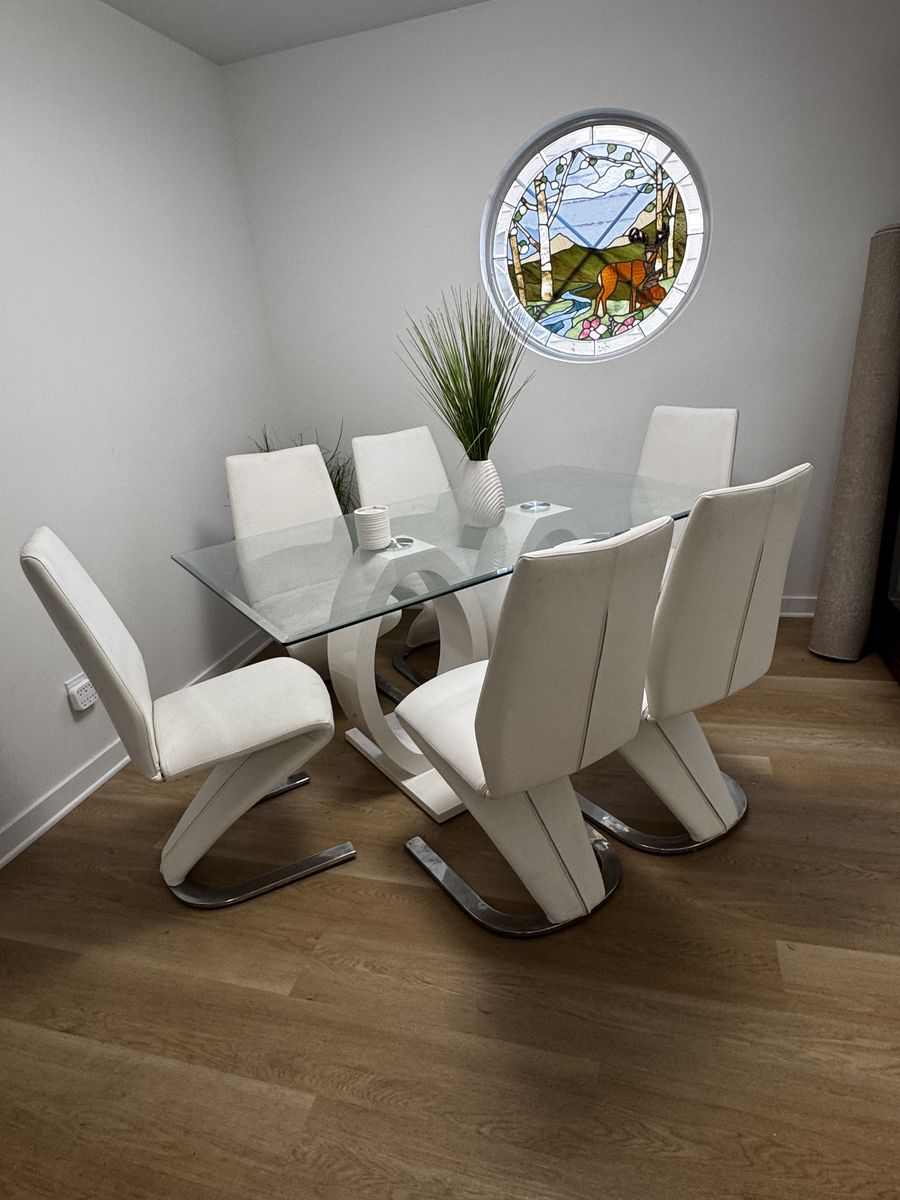 Contemporary chrome and white dining table with 6 leather chairs 