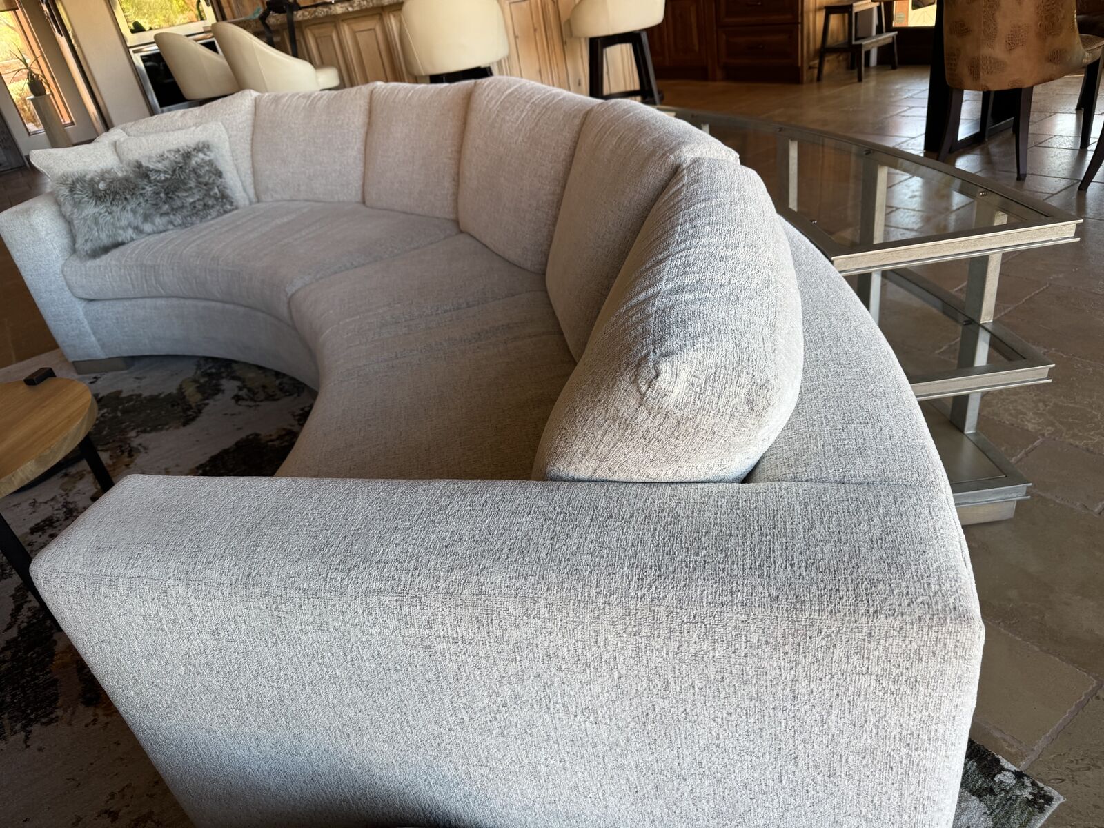 sofa with surrounding glass and wood tables