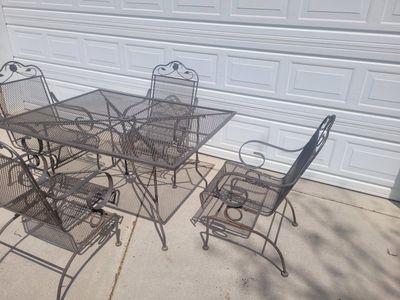 wrought iron patio table and 4 rocking chairs