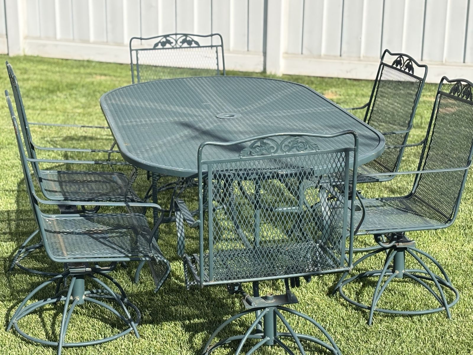 Vintage Woodard Patio Set. Oval table with 6 swivel rocker chairs. Good condition for age. Extremely solid set, built to last! 