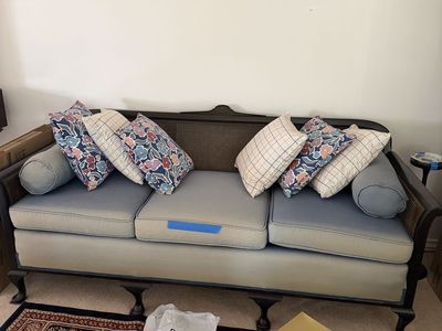 Vintage Cane Back Sofa Couch with Blue Cushions & Floral Accent Pillows