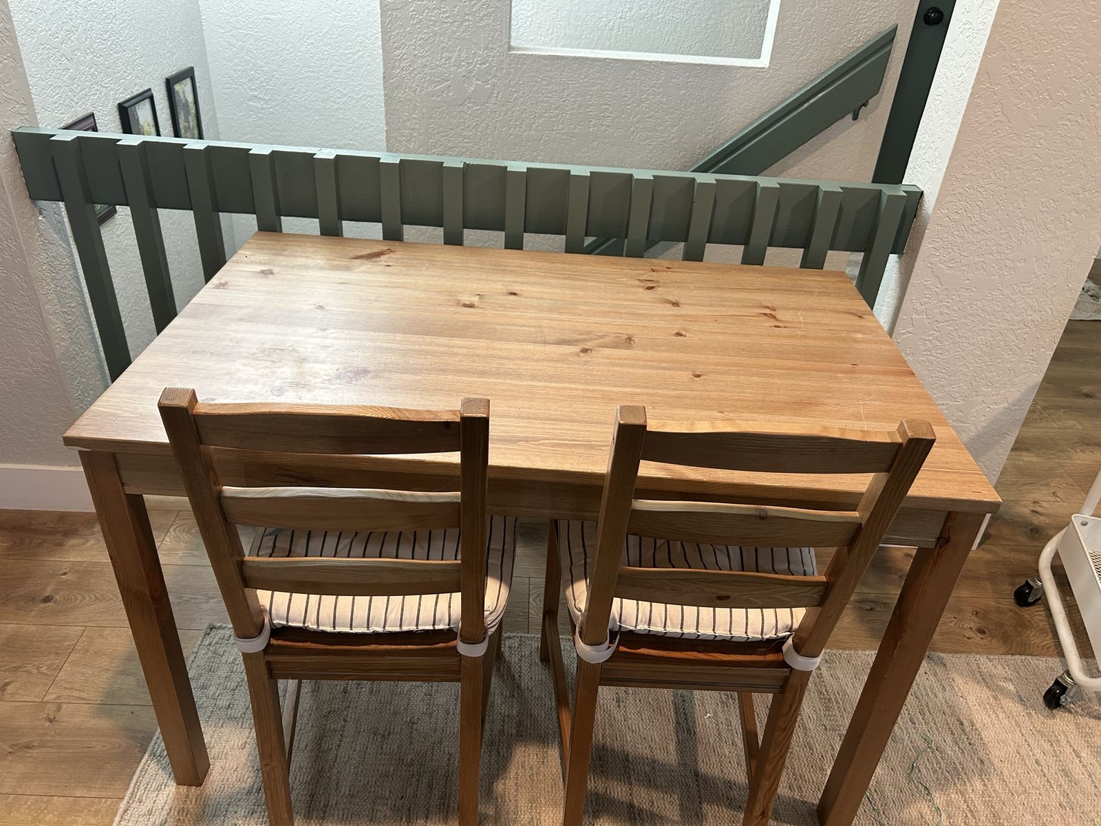 Small table with 4 chairs. Each chair has a matching pad. 