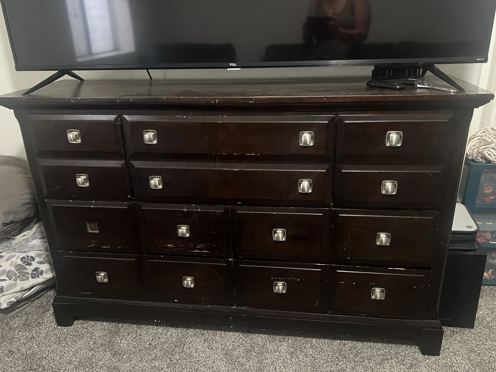 Dark Wood Dresser with Multiple Drawers and Silver Hardware