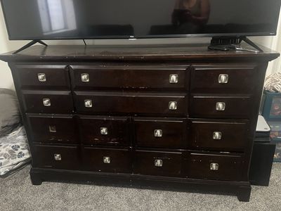 Dark Wood Dresser with Multiple Drawers and Silver Hardware