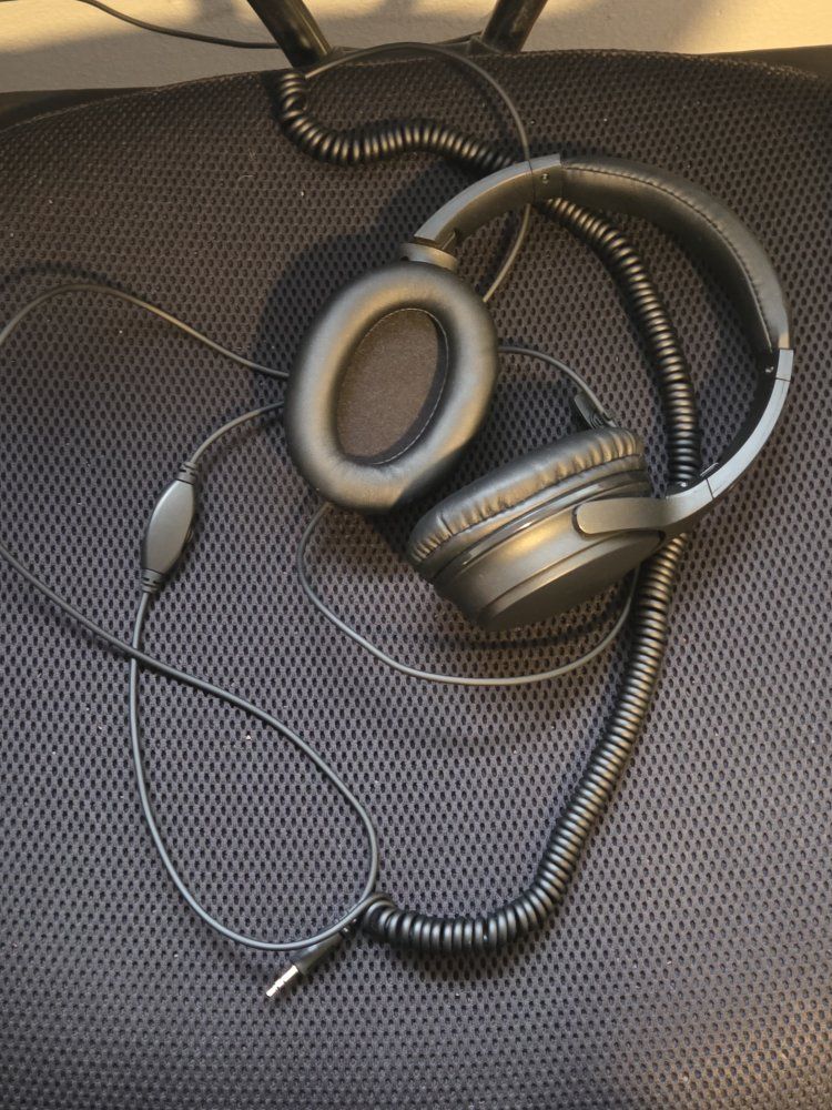Headphones with volume control and coiled cable