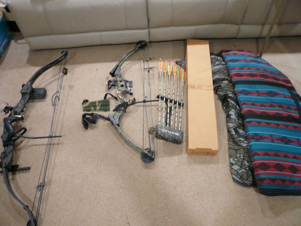 Two bows with sights, release, cases, and arrows and broadheads