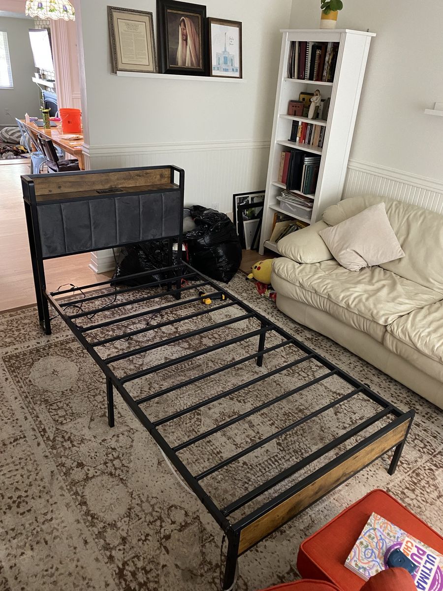 Dark wood and metal twin bed frames with charging station and LED light strips