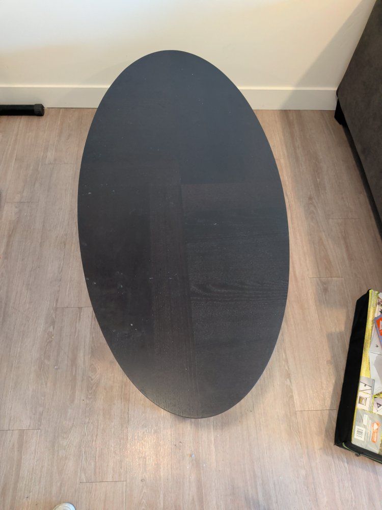 Black Oval Wood Coffee Table with Cross Base