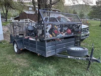Single Axle Utility Trailer with High Mesh Sides, Ramp, and Spare Tire