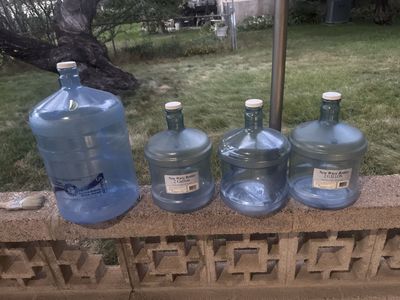 Water Jugs - one 5 Gallon and three 2 Gallon Bottles