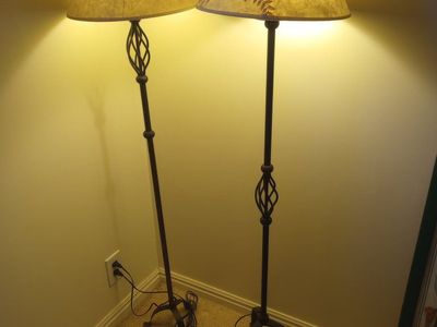Two matching wrought-iron lamps with cloth shades.