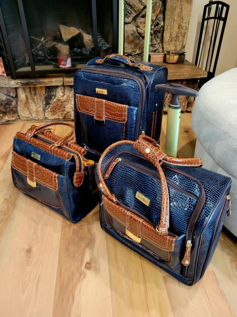 This is a Samantha Brown 3-piece luggage set in navy croc embossed material with brown trim. The set includes a rolling carry-on
