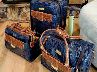 This is a Samantha Brown 3-piece luggage set in navy croc embossed material with brown trim. The set includes a rolling carry-on
