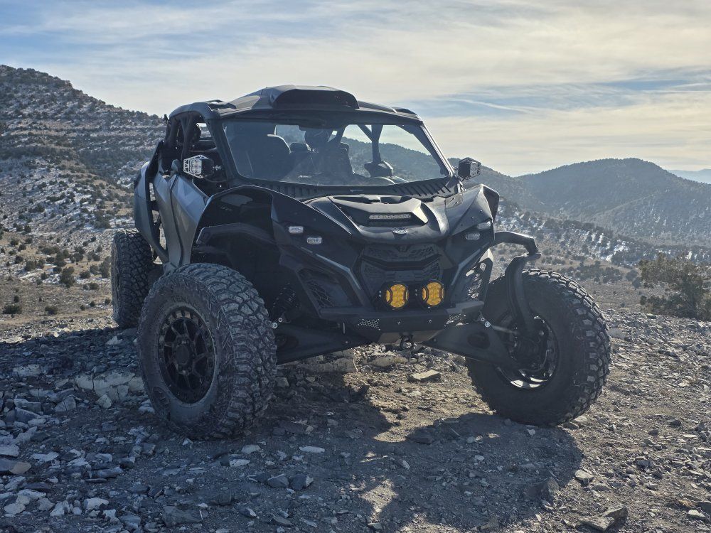 Stock 2025 Mav R Max cage with roof scoop and Bent Metal windshield.
