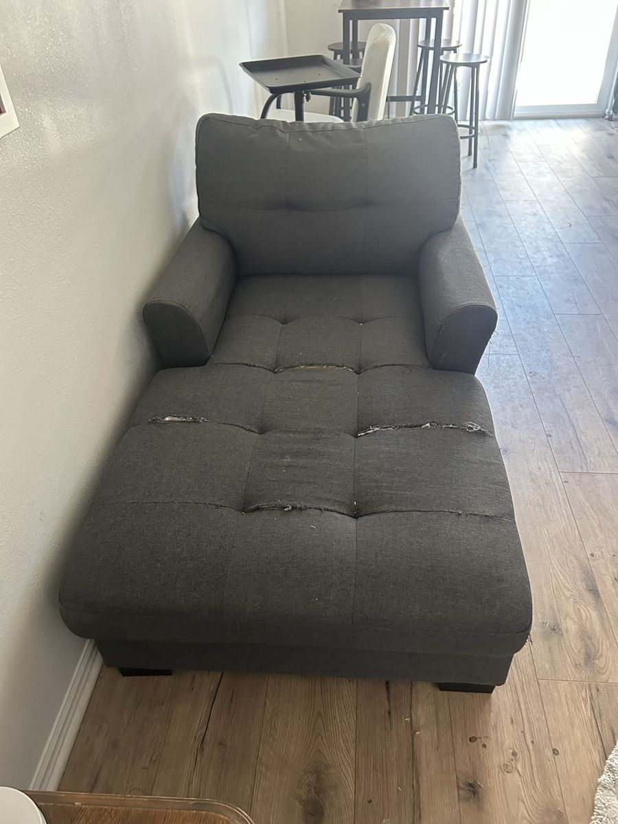 Dark Gray Tufted Chaise Lounge Chair with Visible Fabric Damage