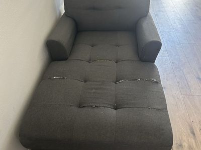 Dark Gray Tufted Chaise Lounge Chair with Visible Fabric Damage