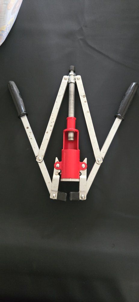 Manual Bottle Capper Tool with Red Housing and Dual Handles