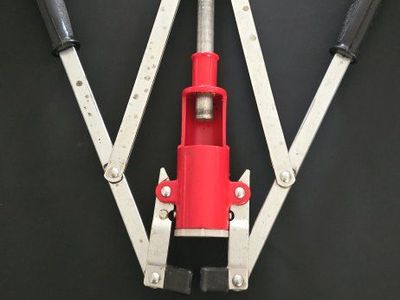 Manual Bottle Capper Tool with Red Housing and Dual Handles