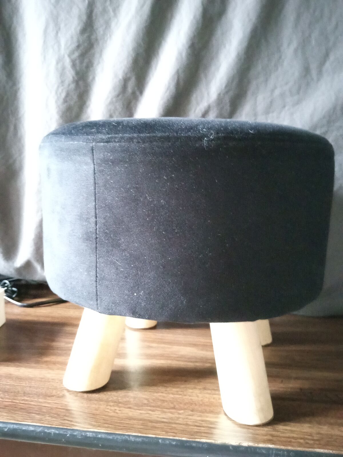 Black velvet ottoman or footstool