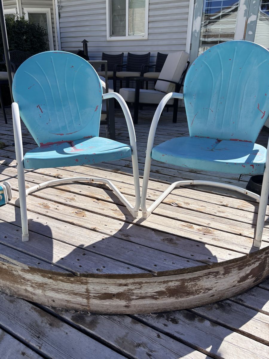 Pair of vintage clamshell metal patio chairs