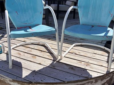 Pair of vintage clamshell metal patio chairs