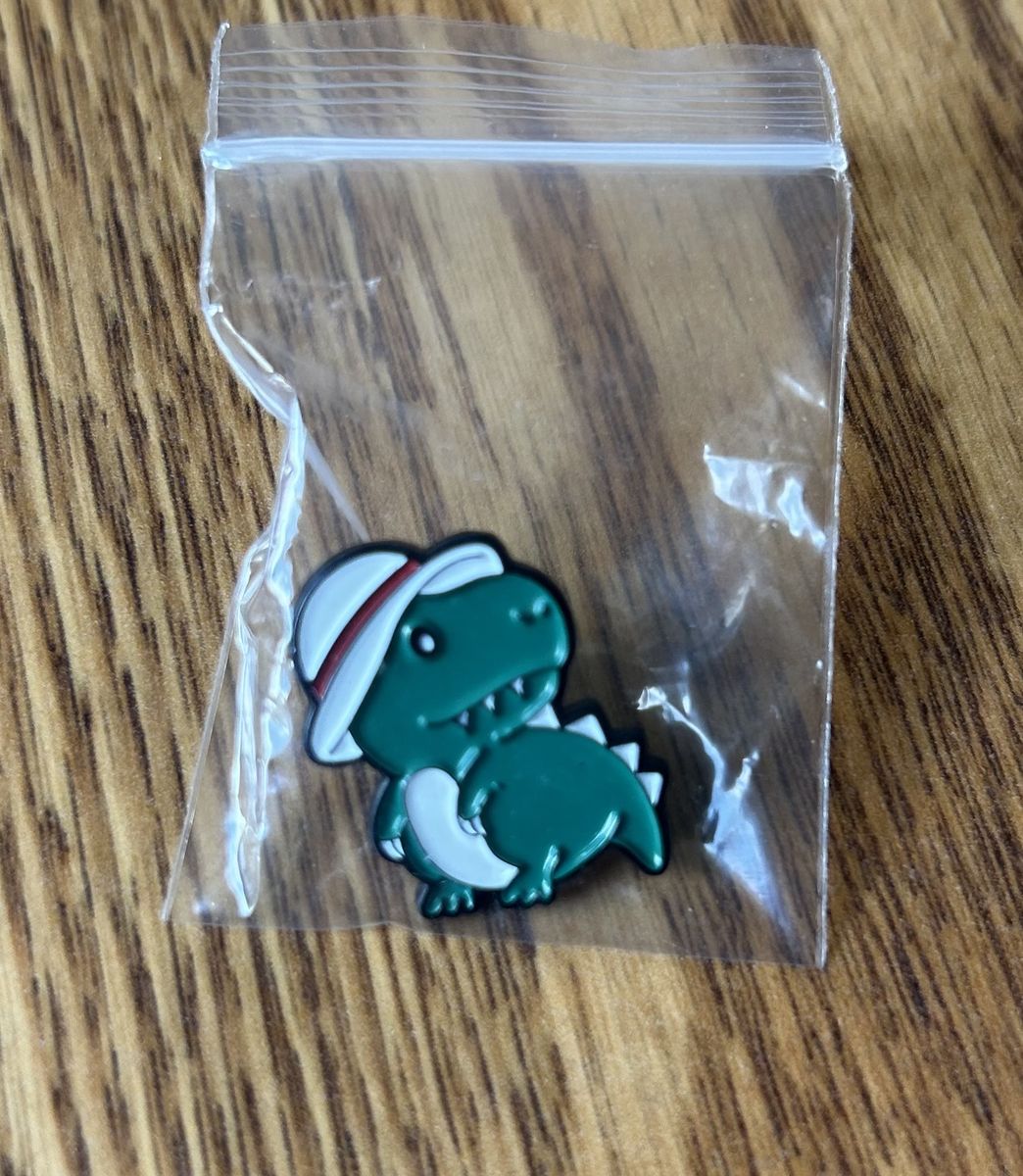 Dinosaur wearing hat pin