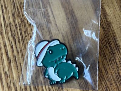 Dinosaur wearing hat pin