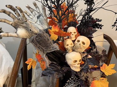 Spooky Halloween Floral Arrangement with Skulls & Zombie Hands in Black Vase