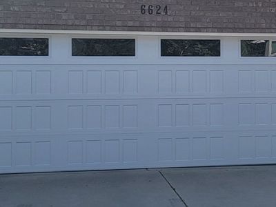 18x7 garage door Insulated, NEW , STEEL BACK WITH WINDOWS