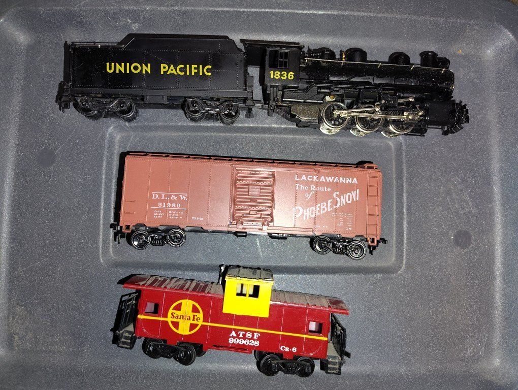 Model train controller, tracks, cars, and locomotives HO scale.