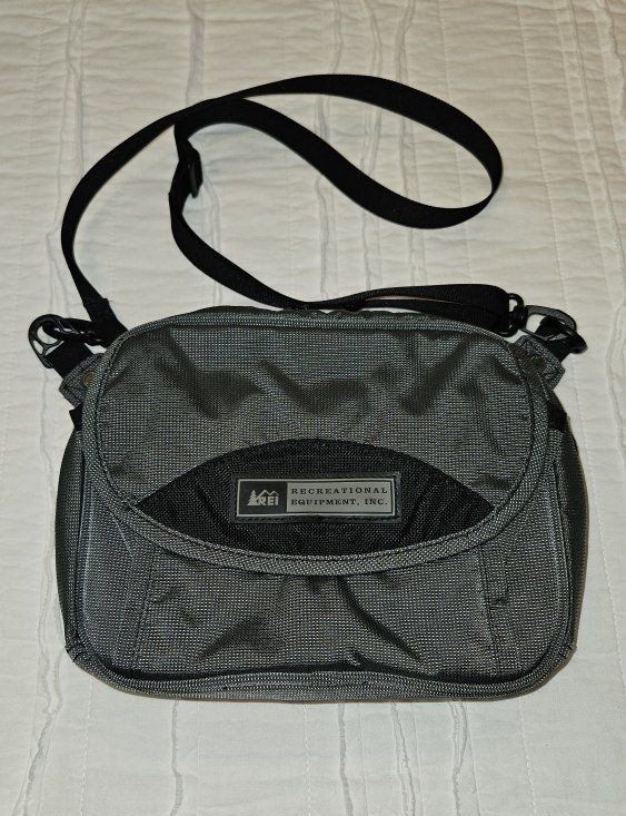 REI Grey Crossbody Travel Bag with multiple pockets and interior storage