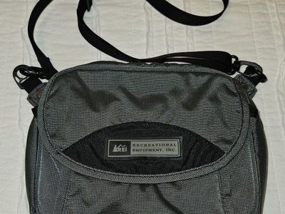 REI Grey Crossbody Travel Bag with multiple pockets and interior storage
