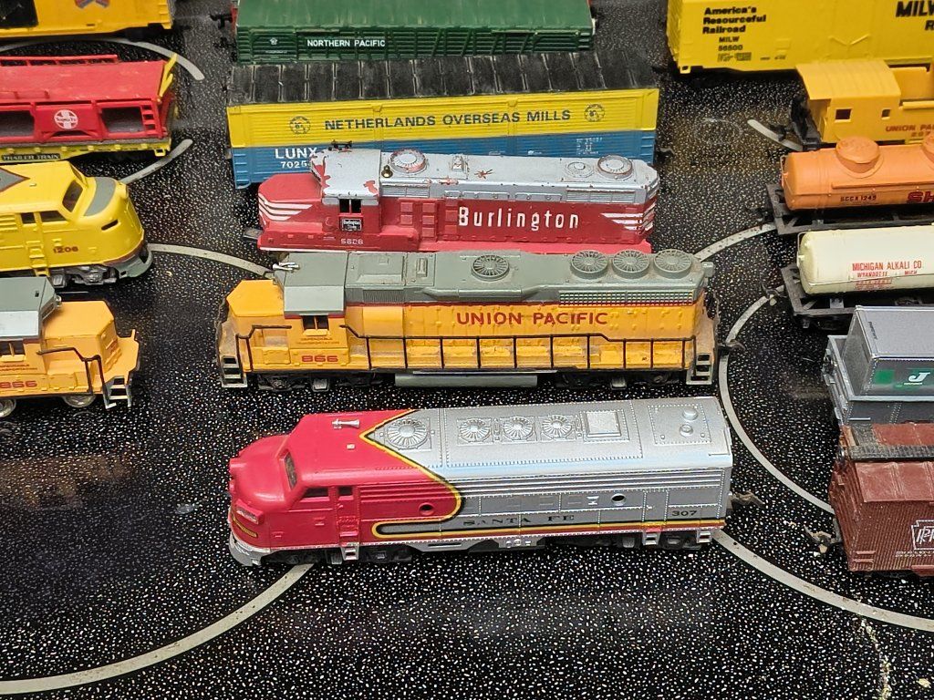 multiple train engines,train cars,track signs,telephone poles, and scenery collection