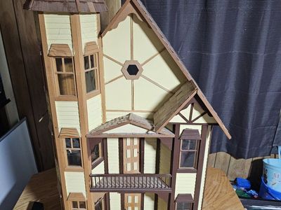 Large Wooden Victorian Dollhouse with Tower, amd furniture included.