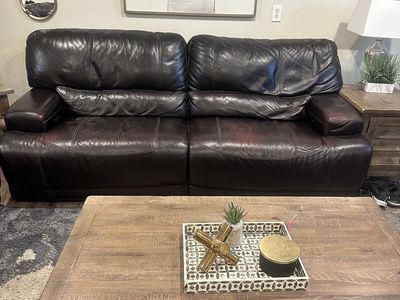 Brown leather reclining couch and love seat.