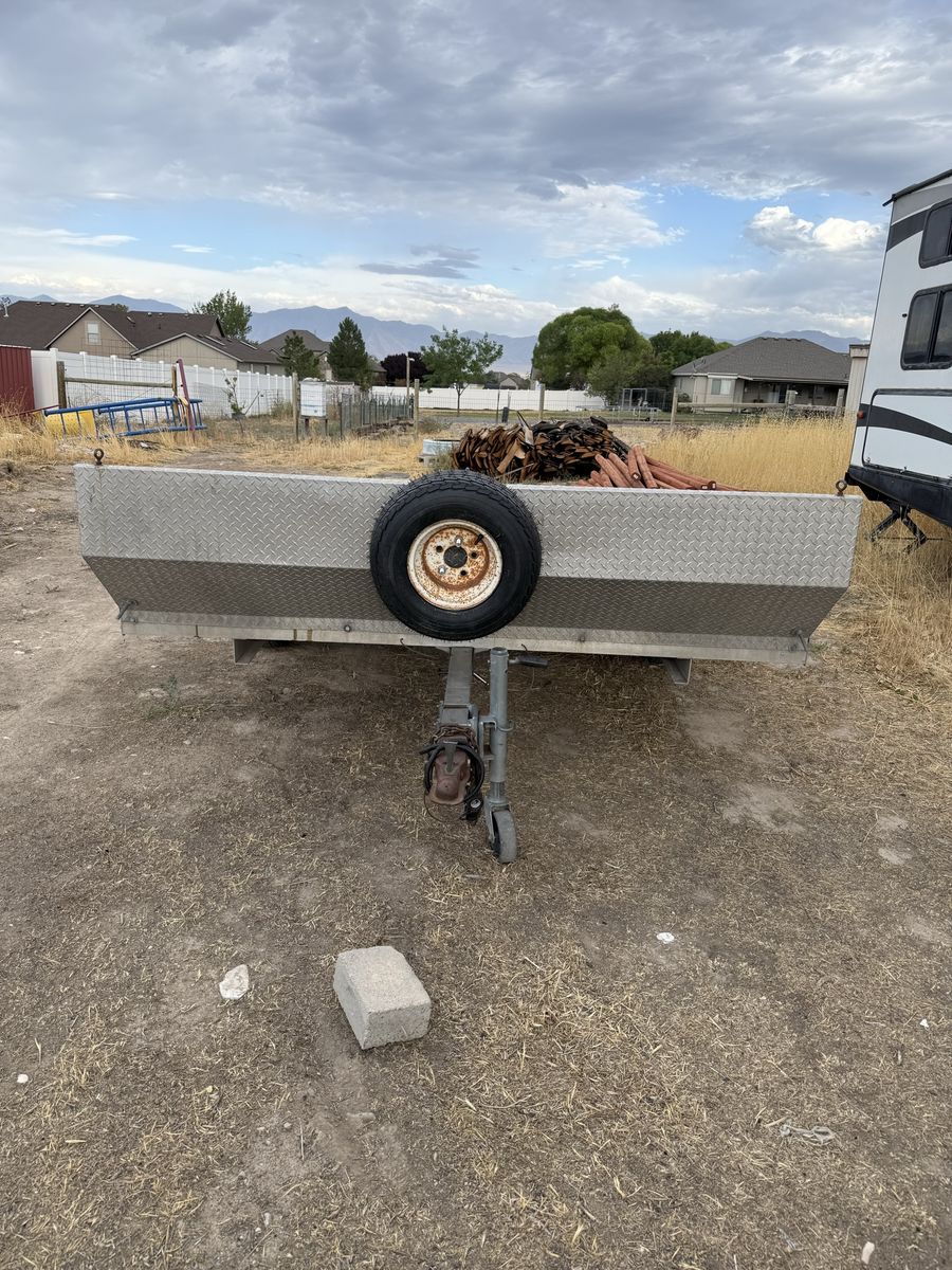 8’x10’ Featherlite aluminum open tilt deck utility trailer.