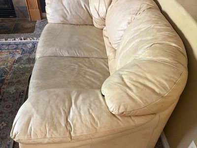 Cream Leather Couch with Visible Wear and Tear.