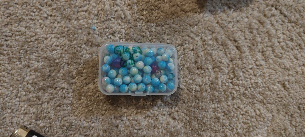 Assorted Blue Glass Beads in Storage Container