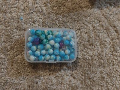 Assorted Blue Glass Beads in Storage Container